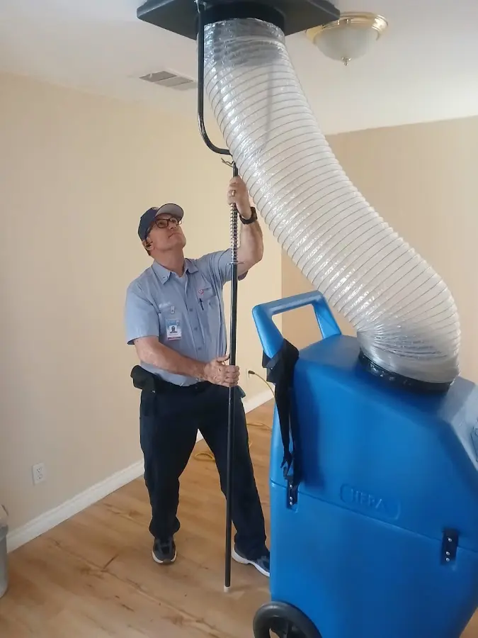 Furnace Tune-Up technician using HEPA equipment in Mango